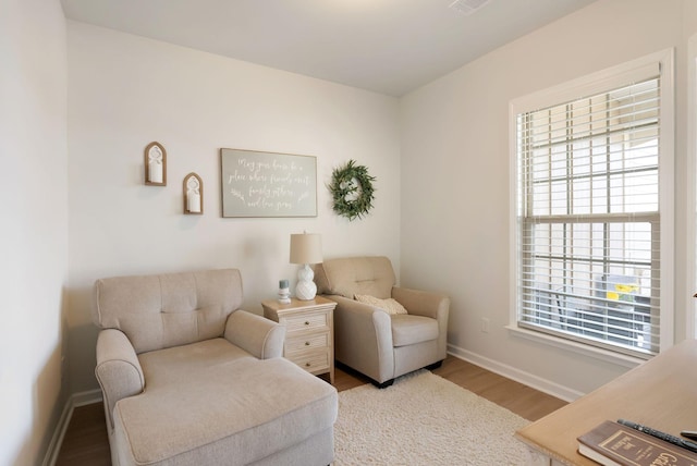 sitting room with wood finished floors and baseboards