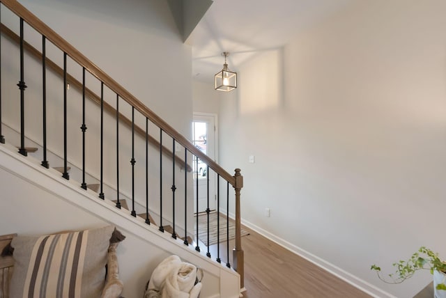 stairs with baseboards and wood finished floors