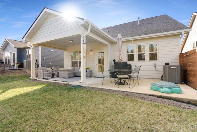 back of property with central AC, an outdoor hangout area, a patio area, and a shingled roof