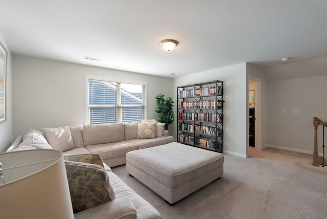 living room featuring light colored carpet and baseboards