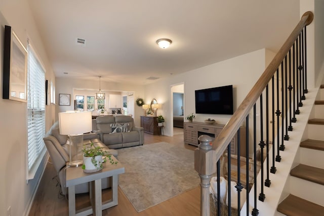 living room with wood finished floors and stairway