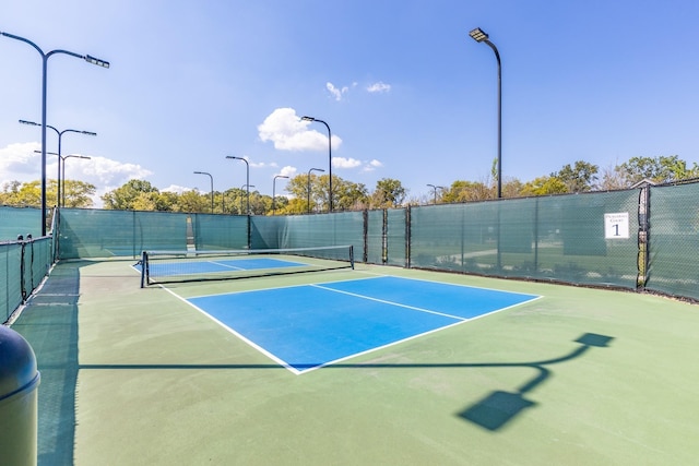 view of tennis court featuring fence
