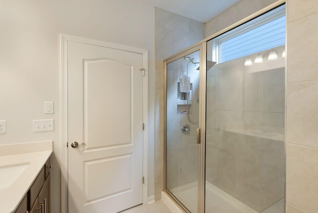 full bathroom featuring a shower stall and vanity