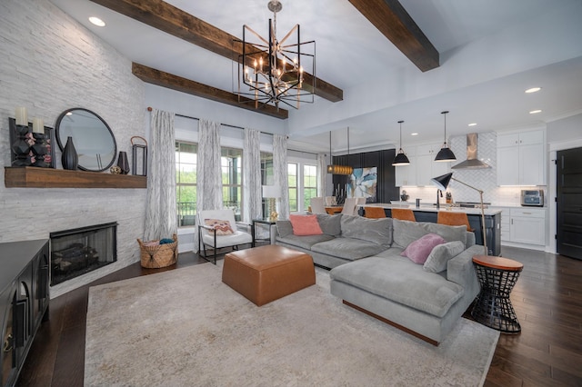 144 Autumn Crk, Lebanon, TN 37087 - living room with beam ceiling, a chandelier, dark wood-type flooring, a stone fireplace, and recessed lighting