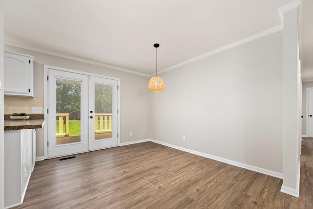 1643 Windy Meadow Dr, Christiana, TN 37037 - unfurnished dining area with light wood-style flooring, french doors, ornamental molding, and baseboards
