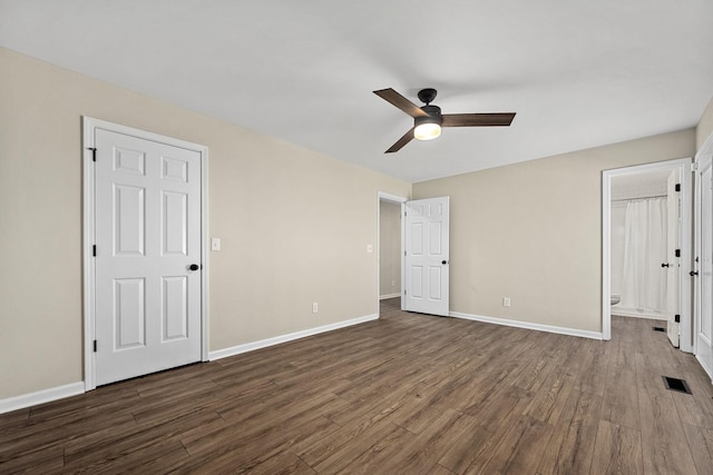 1643 Windy Meadow Dr, Christiana, TN 37037 - unfurnished bedroom featuring dark wood-style floors, baseboards, ensuite bathroom, and a ceiling fan