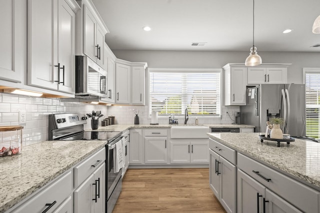 1112 Malinda Ln, Greenbrier, TN 37073 - kitchen featuring appliances with stainless steel finishes, a sink, white cabinets, plenty of natural light, and recessed lighting