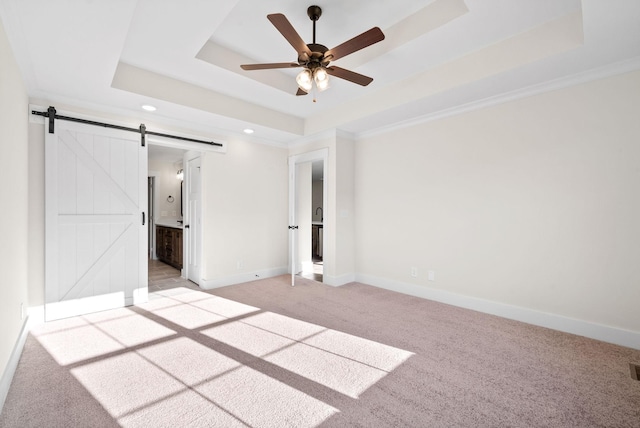1936 Flats Rd, Cunningham, TN 37052 - unfurnished bedroom with a tray ceiling, a barn door, light colored carpet, recessed lighting, and baseboards