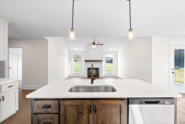 1936 Flats Rd, Cunningham, TN 37052 - kitchen featuring dishwasher, a sink, dark wood-style flooring, light countertops, and open floor plan