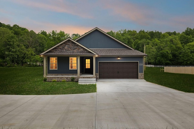 1936 Flats Rd, Cunningham, TN 37052 - view of front of home featuring a garage, covered porch, concrete driveway, and stone siding
