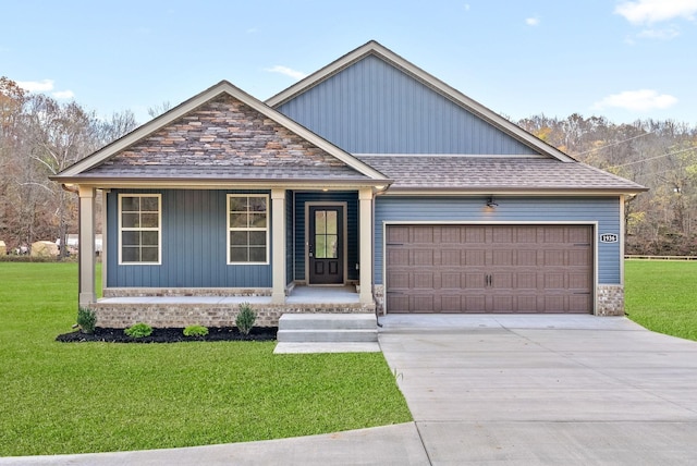 1936 Flats Rd, Cunningham, TN 37052 - view of front facade with an attached garage, a front yard, concrete driveway, and covered porch