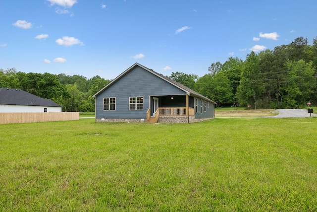 1936 Flats Rd, Cunningham, TN 37052 - rear view of house with a lawn and a porch