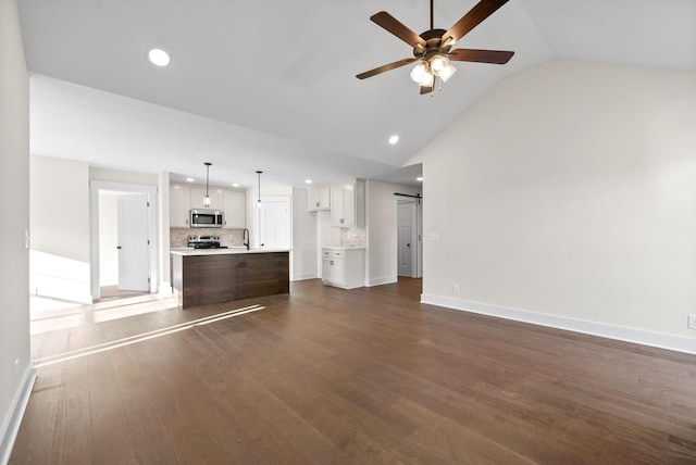 1936 Flats Rd, Cunningham, TN 37052 - unfurnished living room with ceiling fan, recessed lighting, a sink, a barn door, and dark wood-style flooring