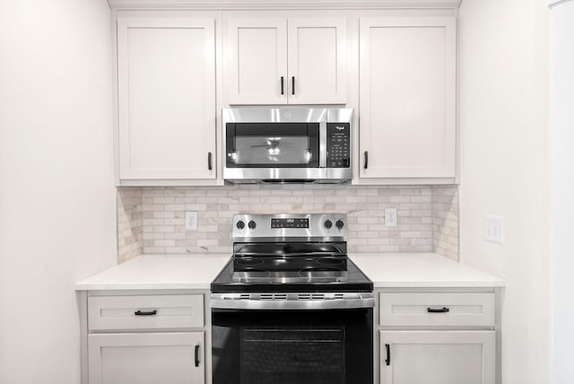 1936 Flats Rd, Cunningham, TN 37052 - kitchen with stainless steel appliances, decorative backsplash, and light countertops