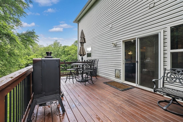 wooden deck featuring outdoor dining area