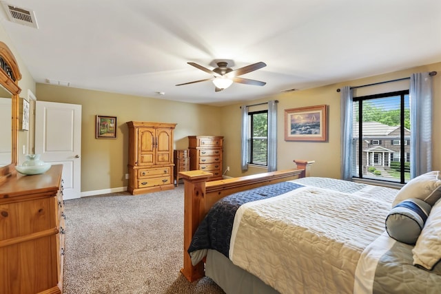 bedroom with multiple windows, carpet, access to exterior, and baseboards