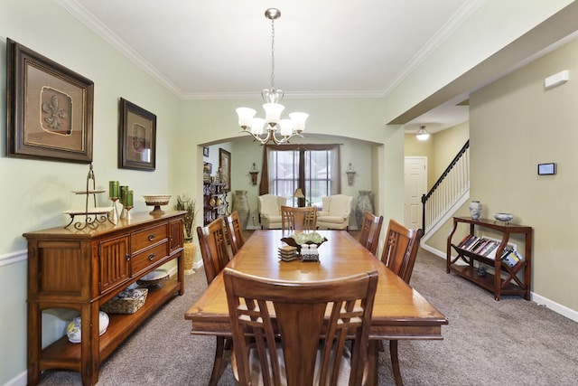 carpeted dining space with a chandelier, stairs, ornamental molding, and baseboards