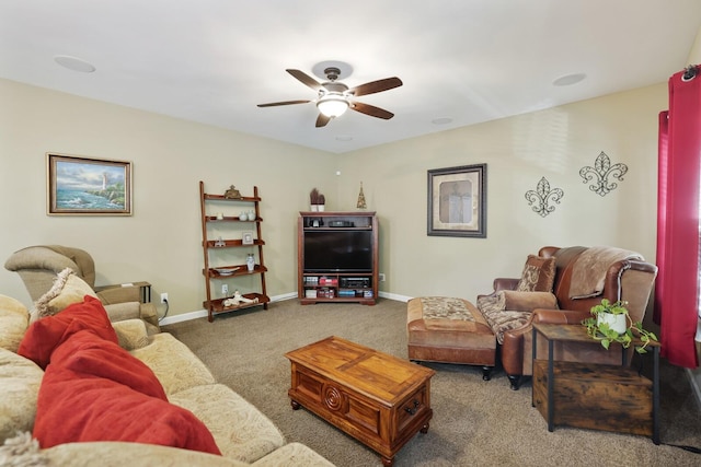 living area featuring ceiling fan, carpet floors, and baseboards