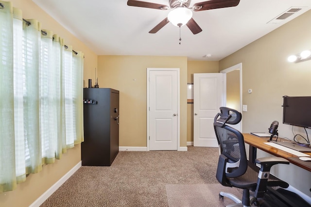 office area featuring light colored carpet, a ceiling fan, and baseboards