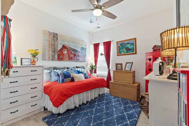 bedroom featuring light wood-style flooring and ceiling fan