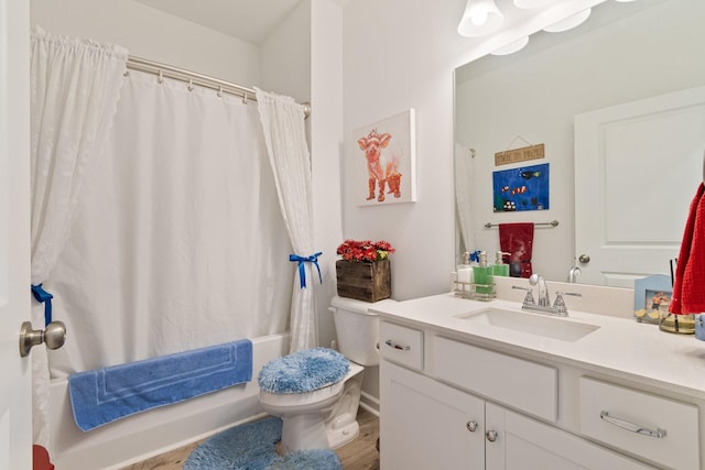 bathroom featuring toilet, vanity, shower / tub combo with curtain, wood finished floors, and baseboards