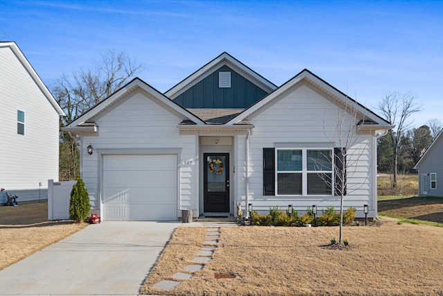 view of front of house with board and batten siding, concrete driveway, and a garage