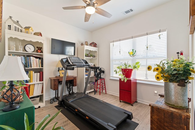 workout area with ceiling fan, wood finished floors, and baseboards