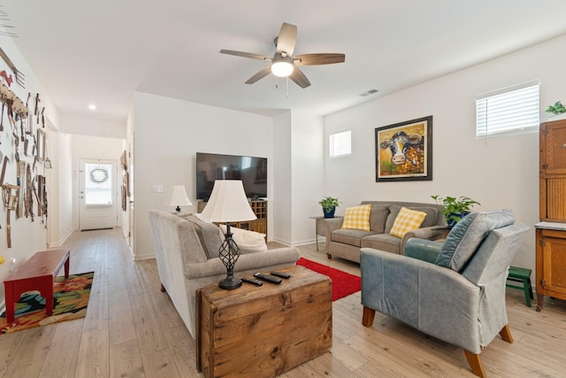 living area with plenty of natural light, ceiling fan, light wood-style floors, and recessed lighting