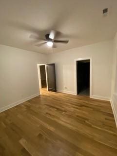 unfurnished bedroom with wood finished floors, baseboards, and a ceiling fan