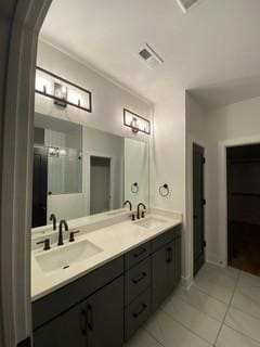 full bathroom featuring tile patterned flooring and double vanity