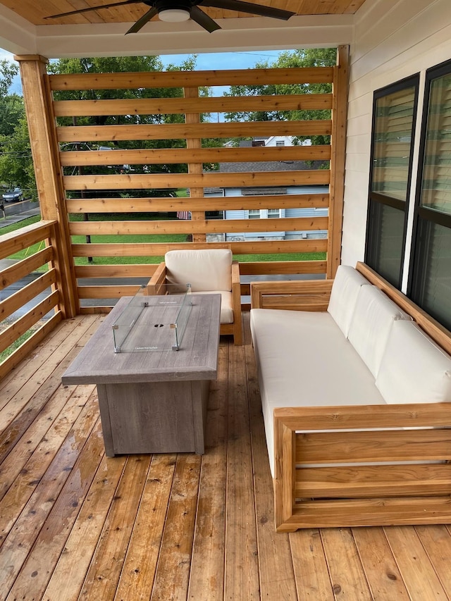 wooden terrace with a ceiling fan