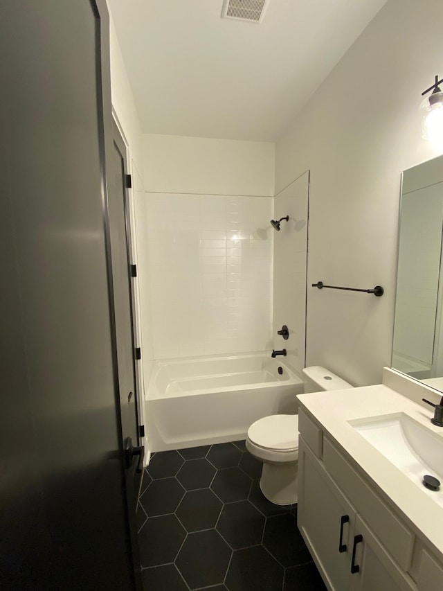 bathroom featuring tile patterned floors, toilet, bathing tub / shower combination, and vanity