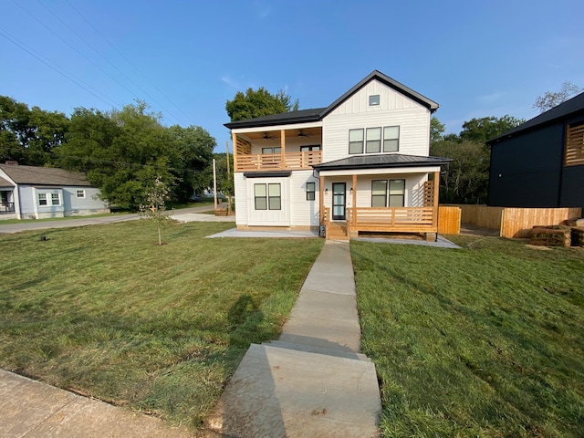view of front facade featuring ceiling fan, metal roof, board and batten siding, a standing seam roof, and a porch
