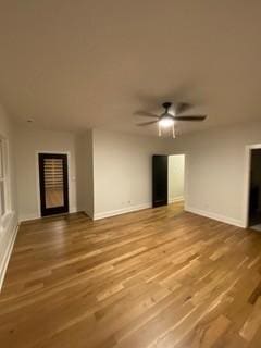unfurnished living room featuring ceiling fan, wood finished floors, and baseboards