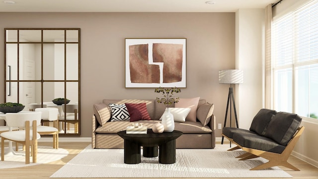 living area featuring light wood-type flooring and baseboards
