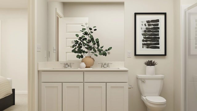 bathroom featuring toilet, double vanity, and baseboards