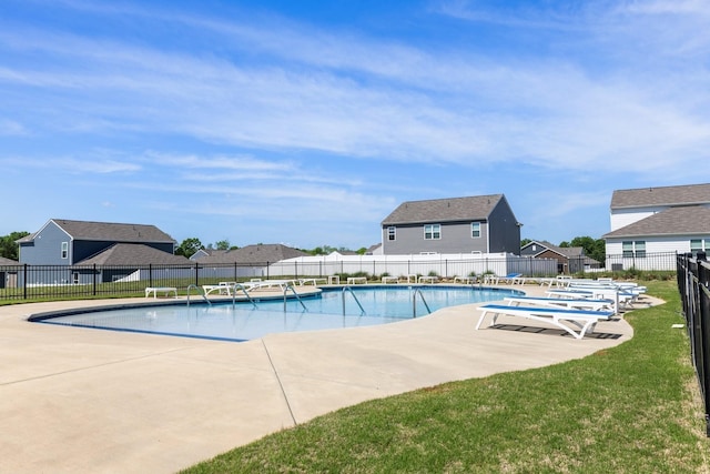 community pool featuring a patio and a residential view