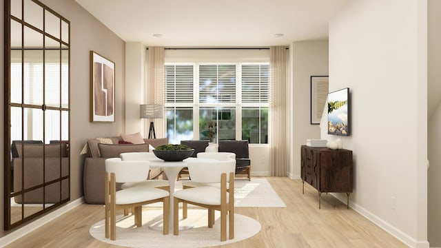 dining area with light wood-type flooring, plenty of natural light, and baseboards