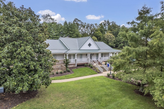 1552 Liberty Pike, Franklin, TN 37067 - farmhouse featuring a standing seam roof, covered porch, a front yard, and metal roof