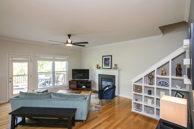 1552 Liberty Pike, Franklin, TN 37067 - living area featuring crown molding, ceiling fan, light wood-type flooring, a fireplace with flush hearth, and baseboards
