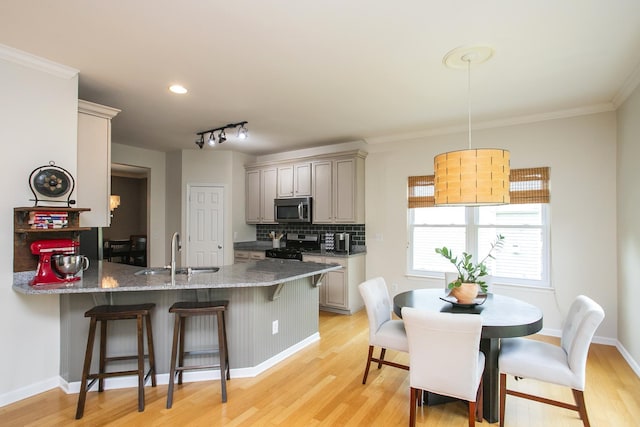 1552 Liberty Pike, Franklin, TN 37067 - kitchen featuring stainless steel microwave, a sink, range with gas cooktop, light wood-style flooring, and gray cabinetry