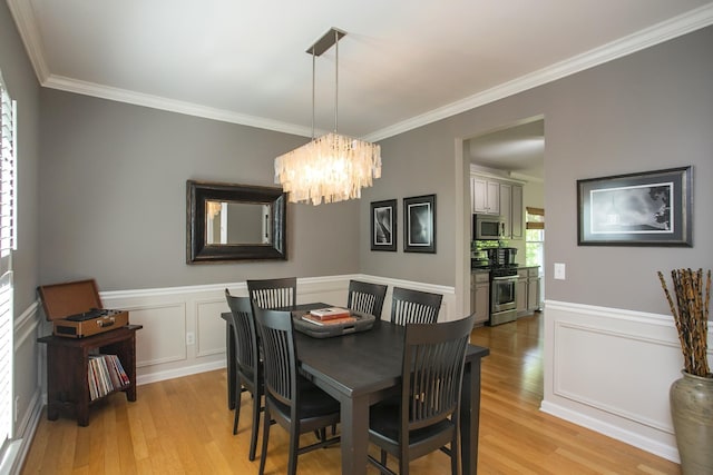 1552 Liberty Pike, Franklin, TN 37067 - dining area featuring light wood-type flooring, ornamental molding, a chandelier, and wainscoting