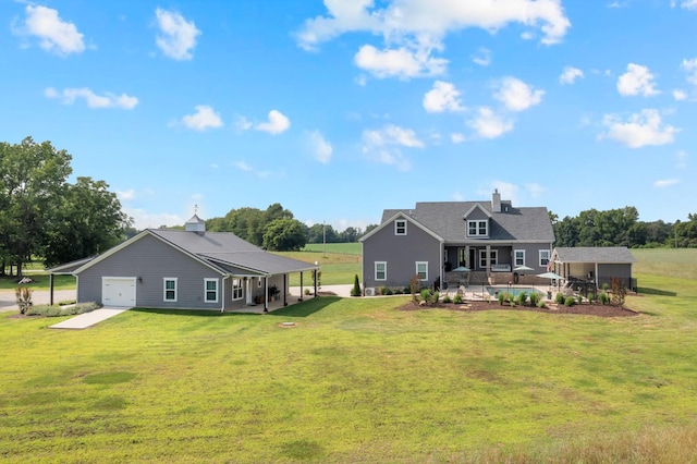 69 Meadows Rd, Hillsboro, TN 37342 - back of property featuring a lawn, a patio, and an attached garage
