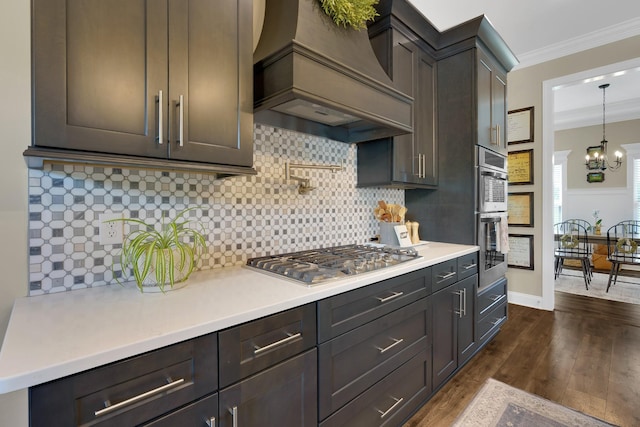 69 Meadows Rd, Hillsboro, TN 37342 - kitchen featuring appliances with stainless steel finishes, premium range hood, ornamental molding, light countertops, and a chandelier