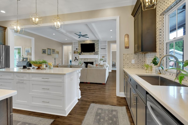 69 Meadows Rd, Hillsboro, TN 37342 - kitchen with dishwasher, a ceiling fan, a fireplace, beam ceiling, and light countertops
