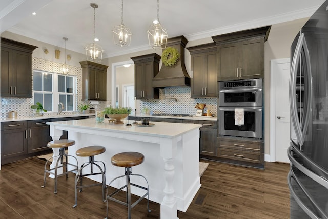 69 Meadows Rd, Hillsboro, TN 37342 - kitchen with appliances with stainless steel finishes, custom exhaust hood, light countertops, dark brown cabinetry, and crown molding