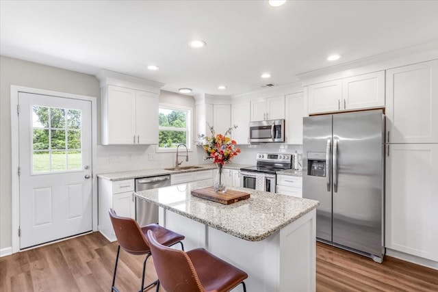 147 Ray Jent Rd, Bethpage, TN 37022 - kitchen featuring appliances with stainless steel finishes, a sink, white cabinetry, wood finished floors, and a kitchen island