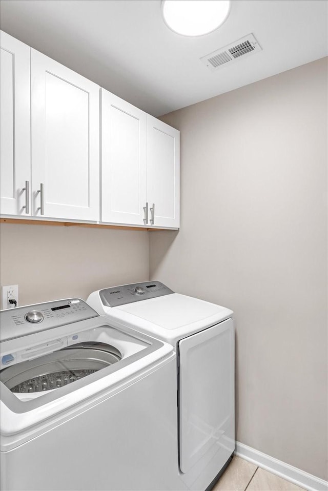 147 Ray Jent Rd, Bethpage, TN 37022 - washroom with cabinet space, washer and dryer, light tile patterned flooring, and baseboards