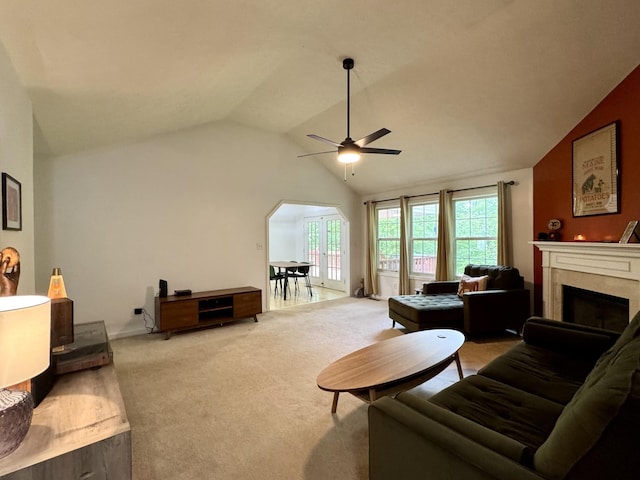 130 Jordan Ln, Hohenwald, TN 38462 - living room featuring lofted ceiling, ceiling fan, light colored carpet, a fireplace, and arched walkways