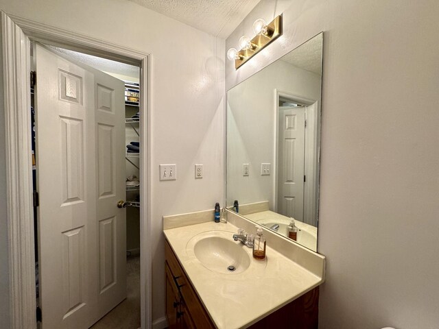 130 Jordan Ln, Hohenwald, TN 38462 - bathroom featuring a textured ceiling and vanity